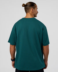 Man wearing MVP 2.0 Oversized Tee - Transformative Teal | Model:Jaiden | Size:M