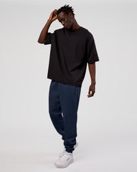 Man wearing MVP Cuffed Track Pant - Future Navy | Model:Okello | Size:M