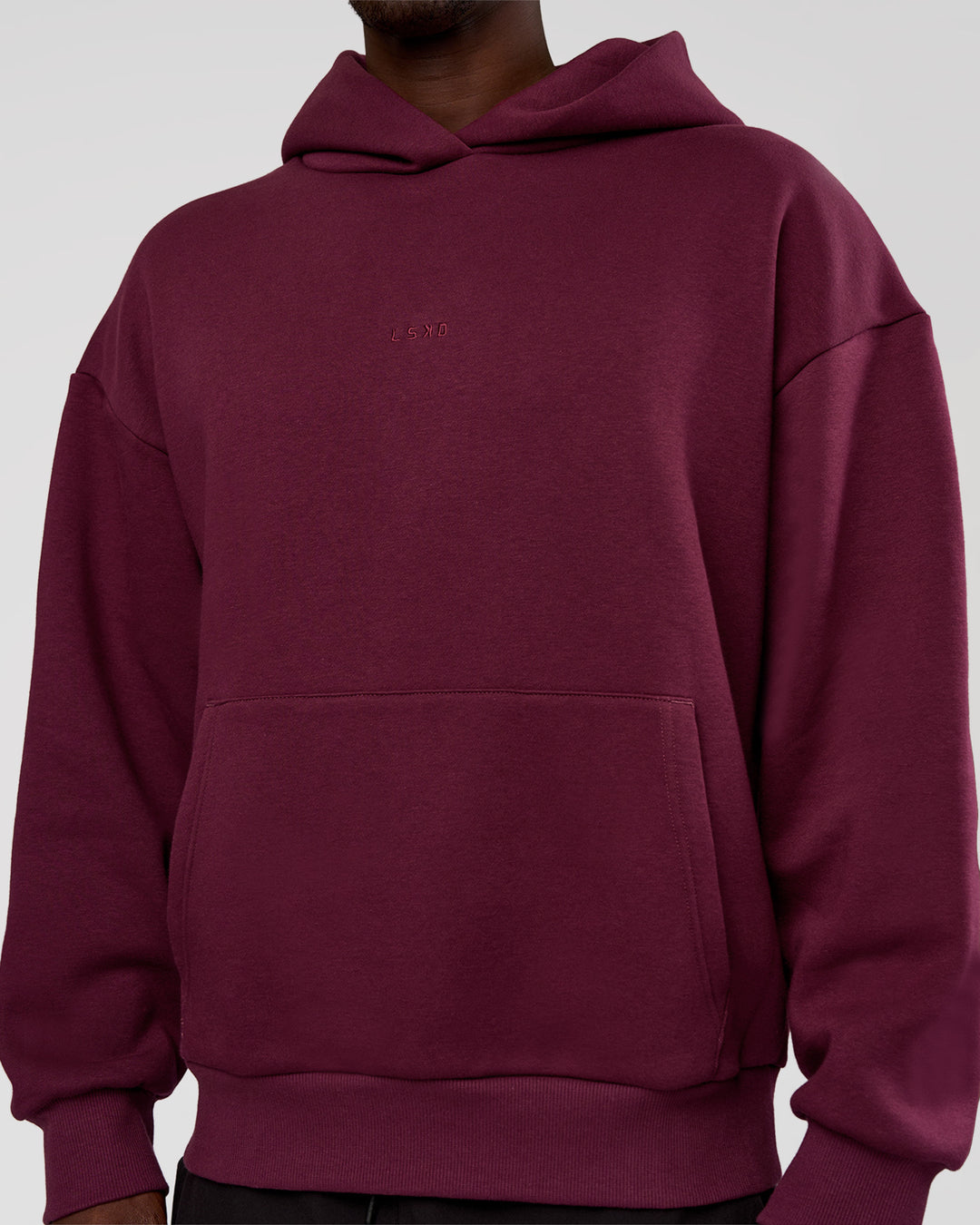 Man wearing MVP Oversized Hoodie - Cherry Lacquer | Model:Okello | Size:M