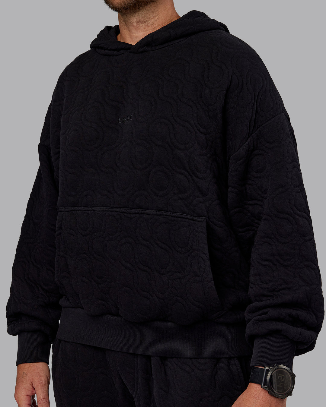 Man wearing MVP Quilted Oversized Hoodie - Black-Geometric | Model:Macca | Size:M