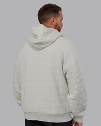Man wearing MVP Quilted Oversized Hoodie in Digital Mist-Geometric | Model:Macca | Size:M