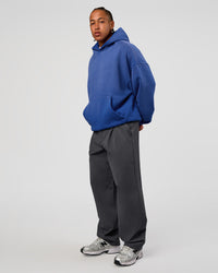 Man wearing Memory In Motion Ultra Heavyweight Washed Hoodie - Electric Indigo Washed | Model:Malebo | Size:M