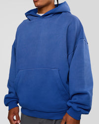 Man wearing Memory In Motion Ultra Heavyweight Washed Hoodie - Electric Indigo Washed | Model:Malebo | Size:M