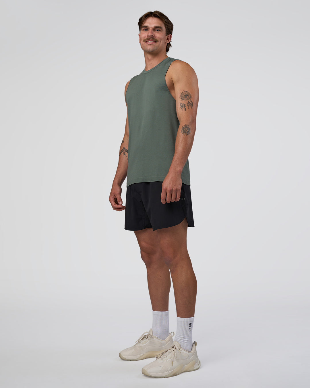 Man wearing AeroFLX+ Seamless Muscle Tank - Graphite/Graphite | Model:Konnor | Size:M