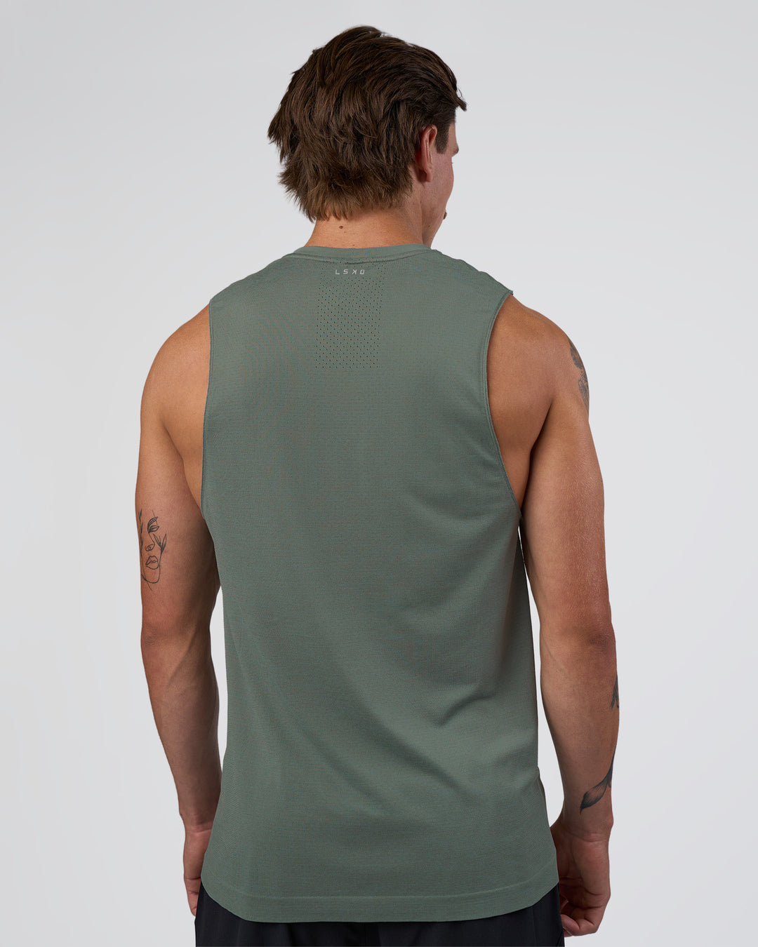 Man wearing AeroFLX+ Seamless Muscle Tank - Graphite/Graphite | Model:Konnor | Size:M