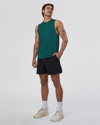 Man wearing AeroFLX+ Seamless Muscle Tank - Transformative Teal/Transformative Teal | Model:Konnor | Size:M