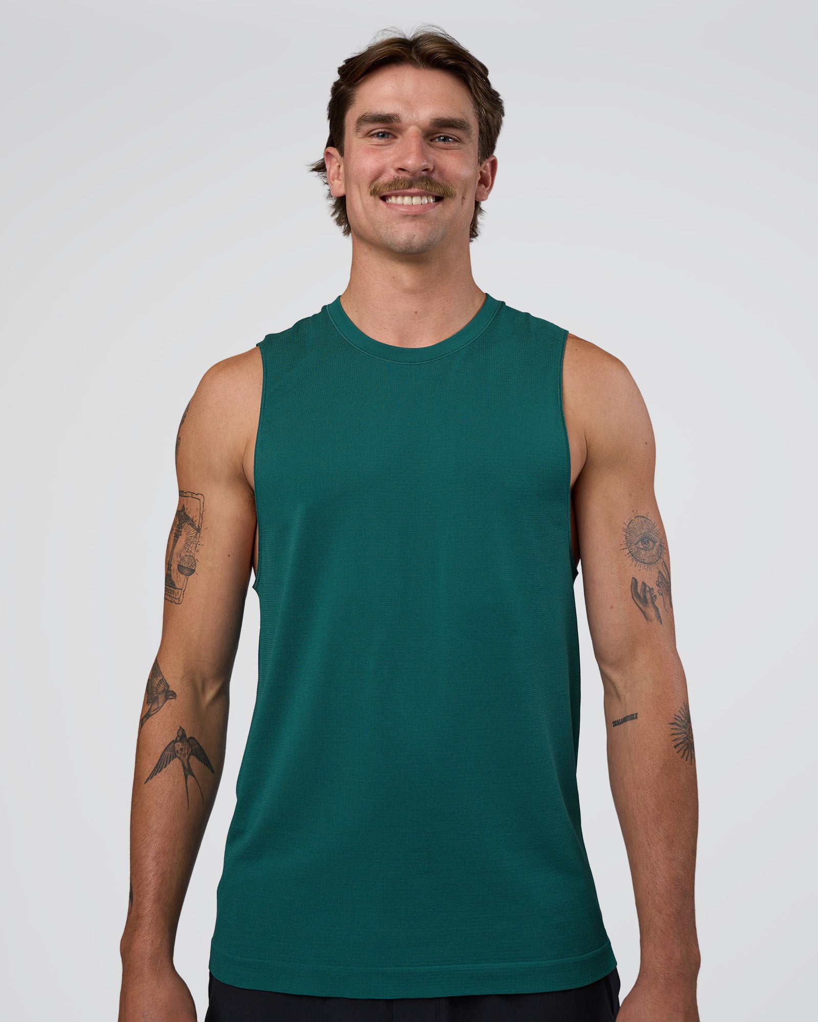 Man wearing AeroFLX+ Seamless Muscle Tank - Transformative Teal/Transformative Teal | Model:Konnor | Size:M