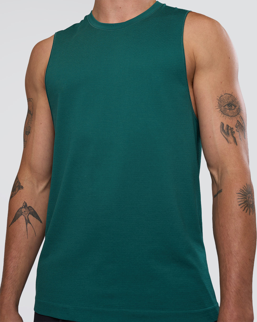 Man wearing AeroFLX+ Seamless Muscle Tank - Transformative Teal/Transformative Teal | Model:Konnor | Size:M