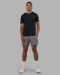 Man wearing AeroFLX+ Seamless Tee - Black Marl | Model:Daarian | Size:M