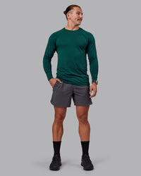 Man wearing AeroFLX+ Seamless Long Sleeve Tee - Dark Moss/Dark Moss | Model:Jaiden | Size:M