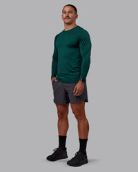Man wearing AeroFLX+ Seamless Long Sleeve Tee - Dark Moss/Dark Moss | Model:Jaiden | Size:M