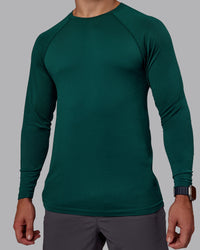Man wearing AeroFLX+ Seamless Long Sleeve Tee - Dark Moss/Dark Moss | Model:Jaiden | Size:M