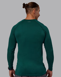 Man wearing AeroFLX+ Seamless Long Sleeve Tee - Dark Moss/Dark Moss | Model:Jaiden | Size:M