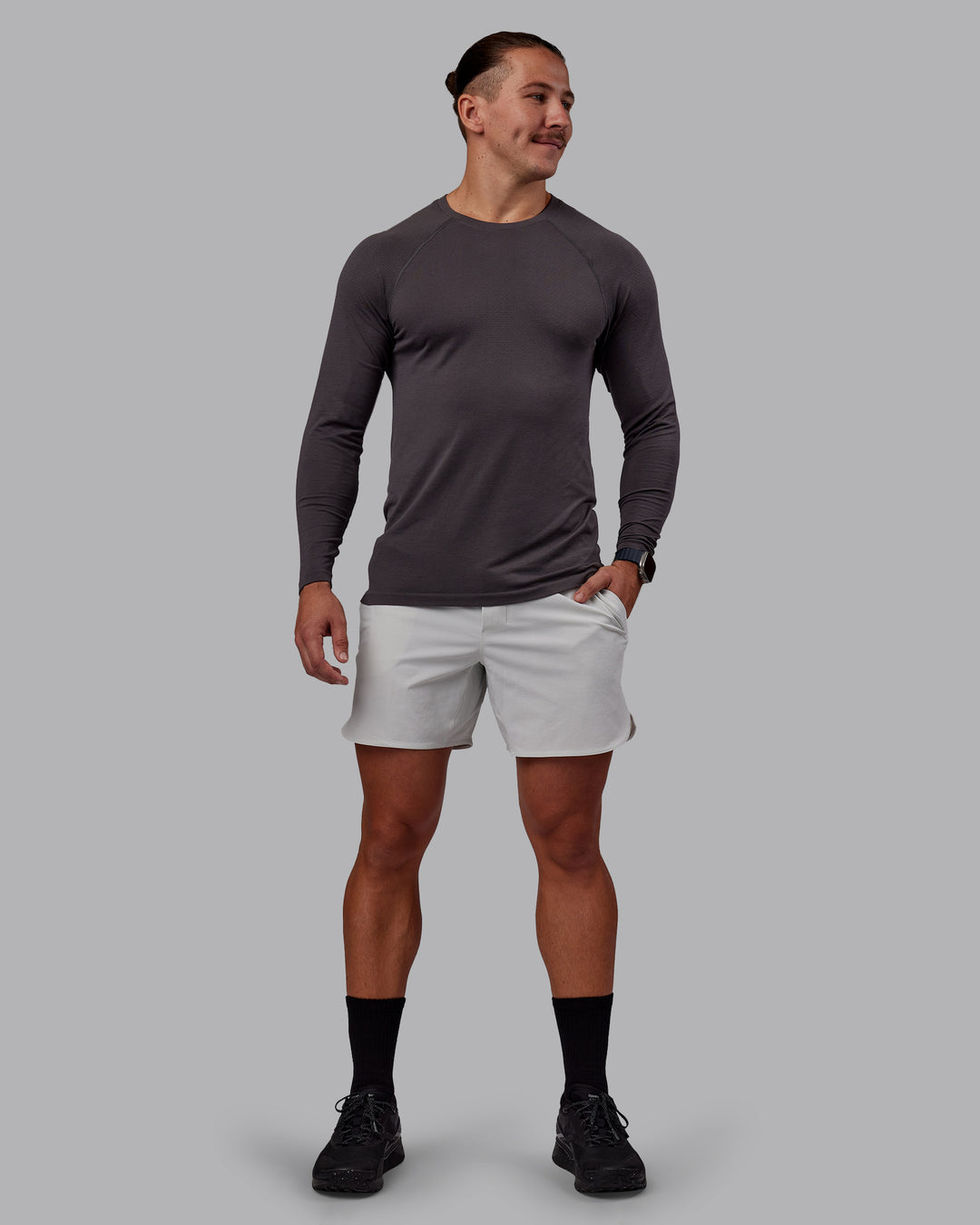 Man wearing AeroFLX+ Seamless Long Sleeve Tee - Dark Storm/Dark Storm | Model:Jaiden | Size:M