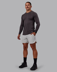 Man wearing AeroFLX+ Seamless Long Sleeve Tee - Dark Storm/Dark Storm | Model:Jaiden | Size:M