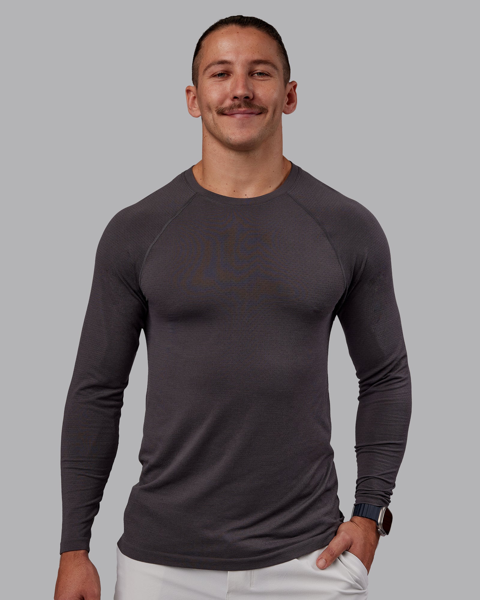 Man wearing AeroFLX+ Seamless Long Sleeve Tee - Dark Storm/Dark Storm | Model:Jaiden | Size:M