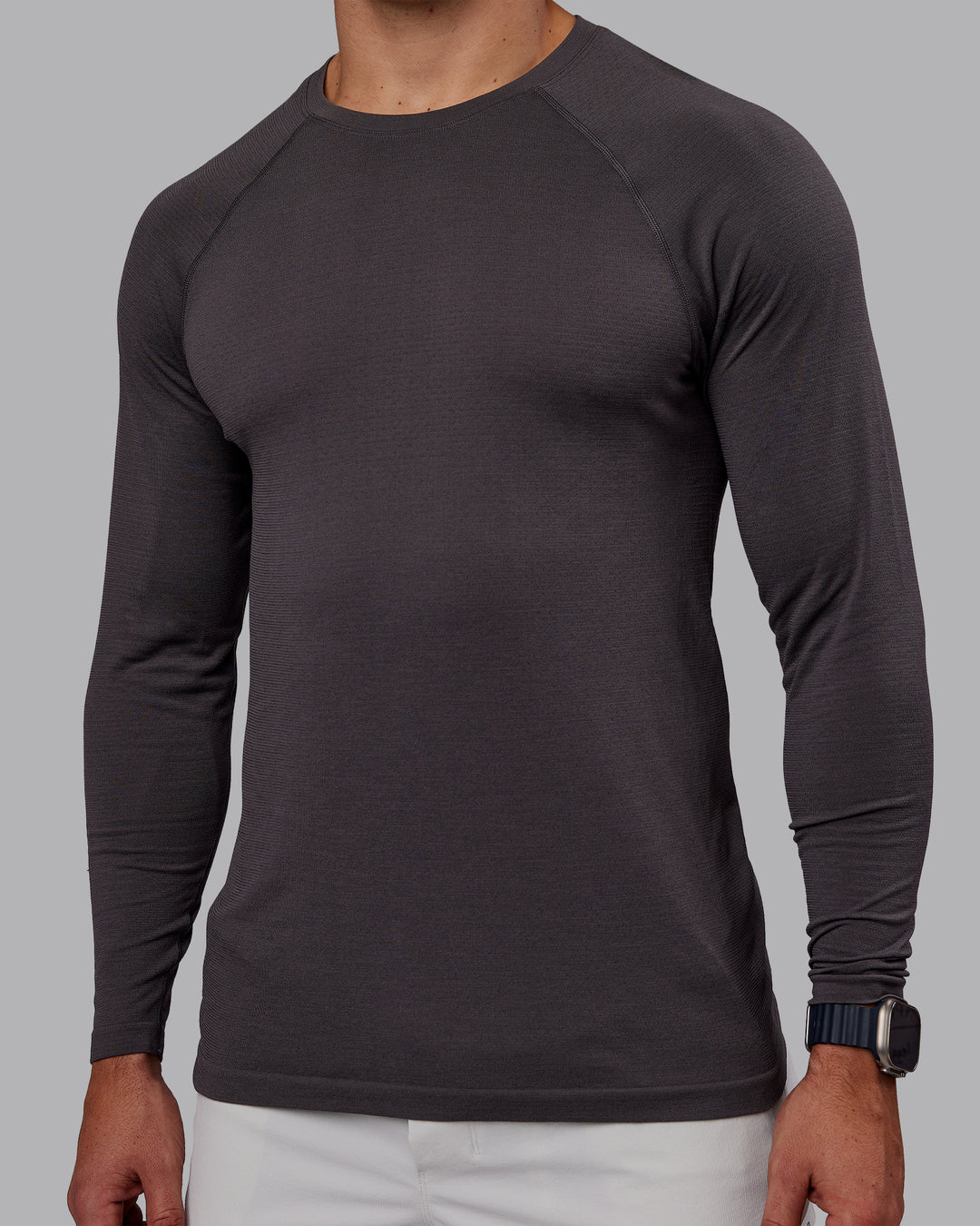 Man wearing AeroFLX+ Seamless Long Sleeve Tee - Dark Storm/Dark Storm | Model:Jaiden | Size:M