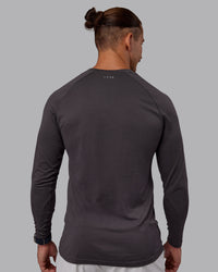 Man wearing AeroFLX+ Seamless Long Sleeve Tee - Dark Storm/Dark Storm | Model:Jaiden | Size:M