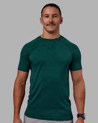 Man wearing AeroFLX+ Seamless Tee - Dark Moss/Dark Moss | Model:Jaiden | Size:M
