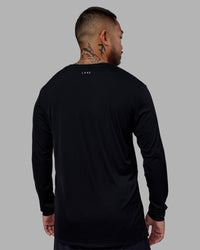Man wearing Pace Running Long Sleeve Top - Black | Model:Justin | Size:M