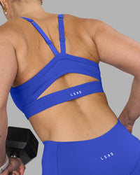 Woman wearing Momentum Sports Bra - Power Cobalt | Model:Amy | Size:M
