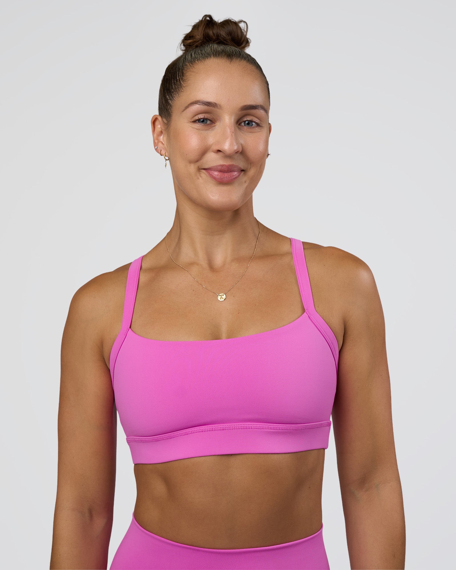 Woman wearing Momentum Sports Bra - Ultra Fuchsia | Model:Abbey | Size:M