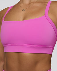Woman wearing Momentum Sports Bra - Ultra Fuchsia | Model:Abbey | Size:M