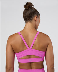 Woman wearing Momentum Sports Bra - Ultra Fuchsia | Model:Abbey | Size:M