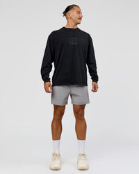 Man wearing Move Fast Heavyweight Oversized Long Sleeve Tee - Black Washed | Model:Jaiden | Size:M