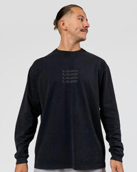Man wearing Move Fast Heavyweight Oversized Long Sleeve Tee - Black Washed | Model:Jaiden | Size:M