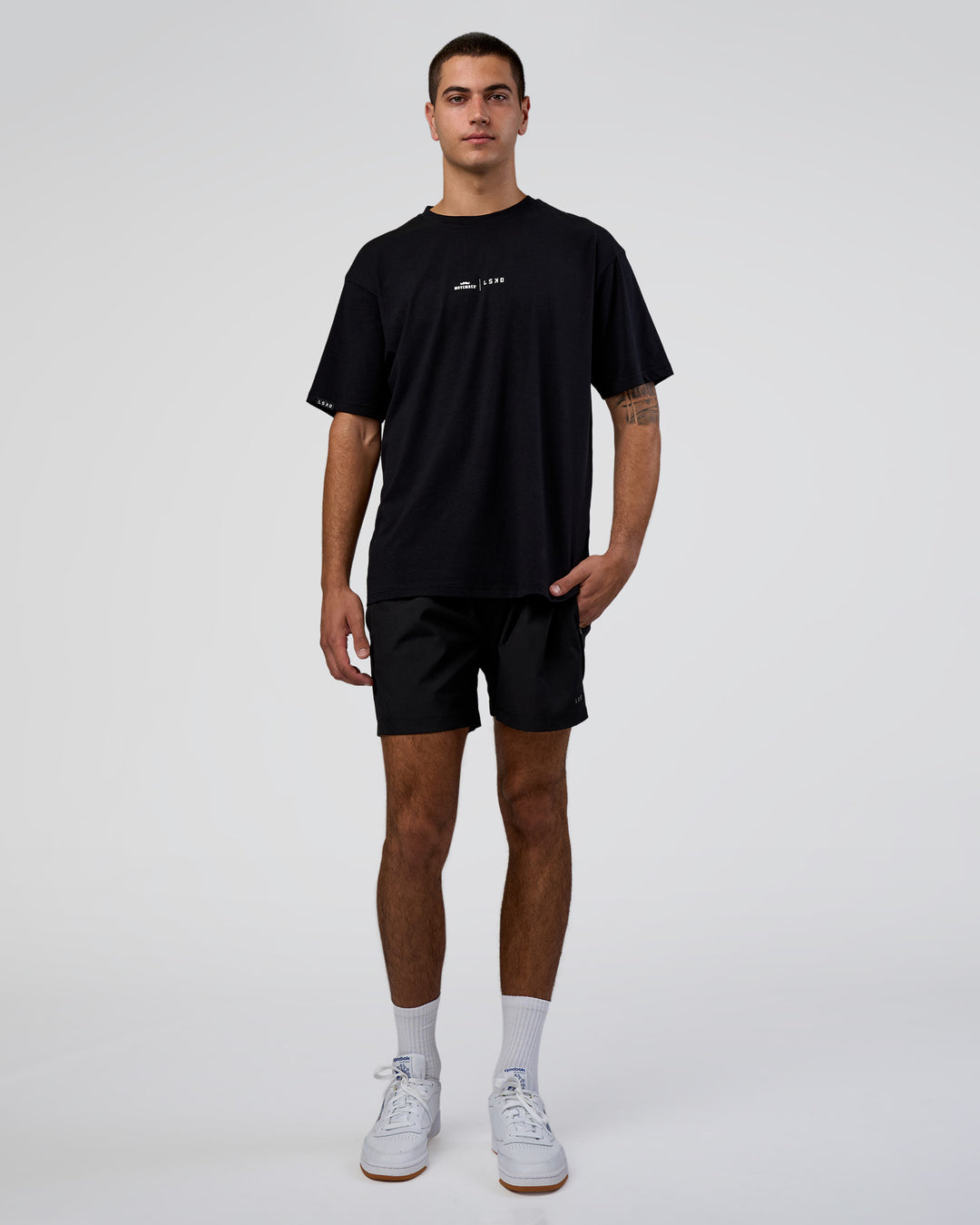 Man wearing Movember 2025 FLXCotton Oversize Tee - Black | Model:Zoran | Size:M