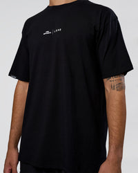 Man wearing Movember 2025 FLXCotton Oversize Tee - Black | Model:Zoran | Size:M