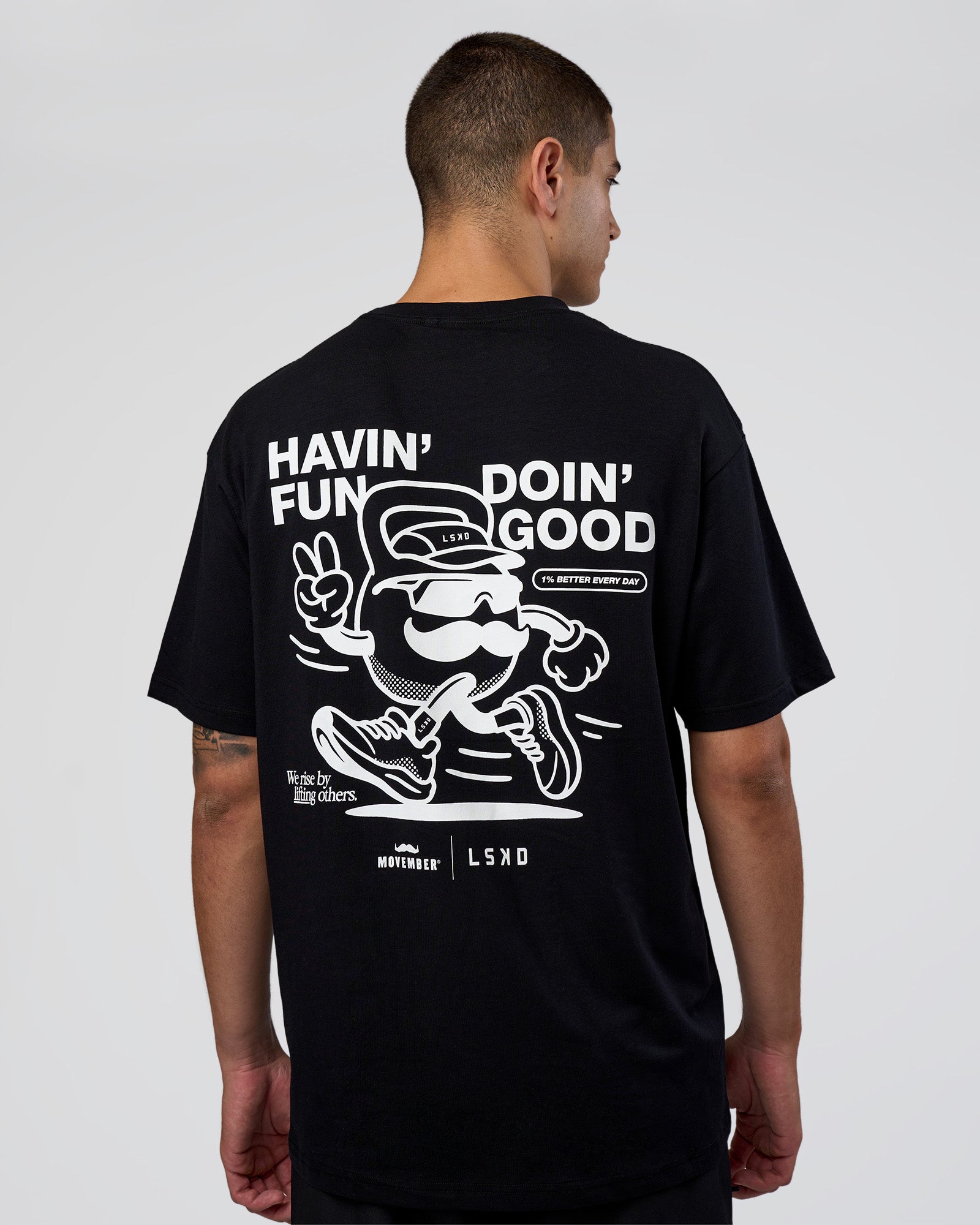 Man wearing Movember 2025 FLXCotton Oversize Tee - Black | Model:Zoran | Size:M