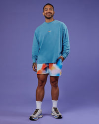 Man wearing Our Journey Oversize Heavyweight FLXCotton Long Sleeve Tee - Azure Blue | Model:Justin | Size:M