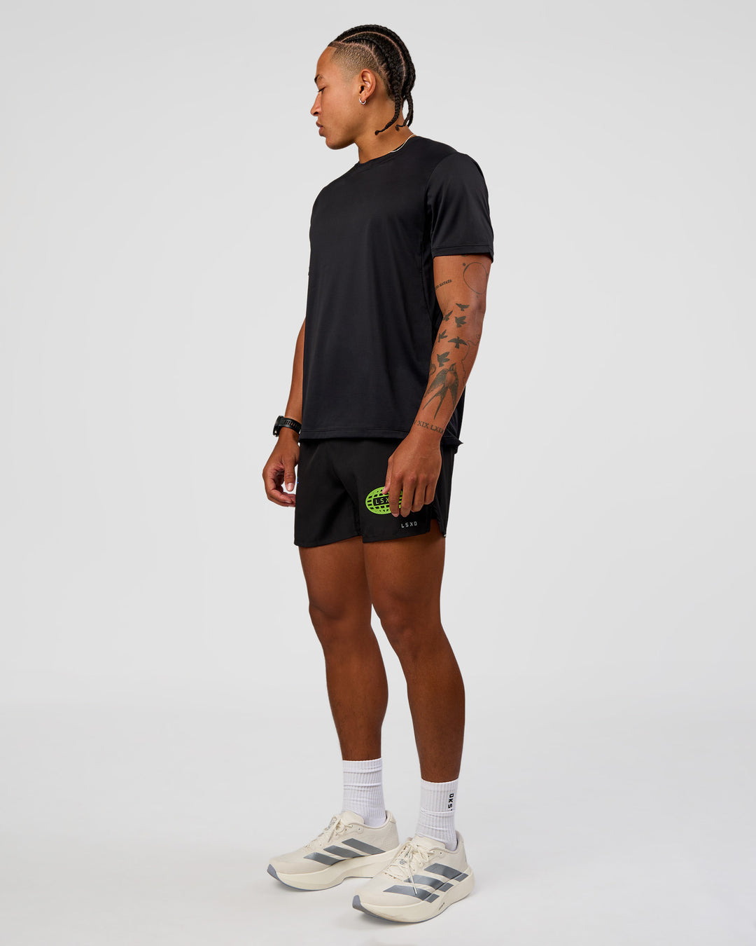 Man wearing Pace 5" Lined Running Short - Black-Lime Glo Indigo | Model:Malebo | Size:M