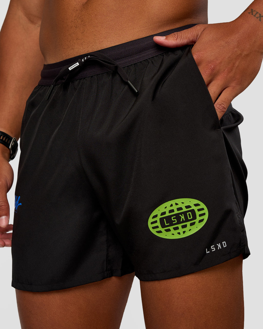 Man wearing Pace 5" Lined Running Short - Black-Lime Glo Indigo | Model:Malebo | Size:M
