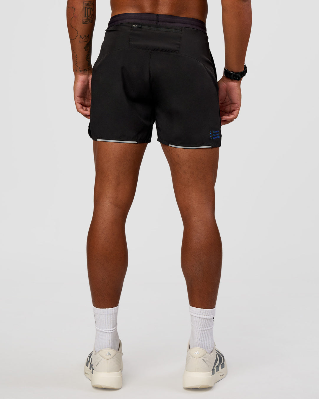 Man wearing Pace 5" Lined Running Short - Black-Lime Glo Indigo | Model:Malebo | Size:M