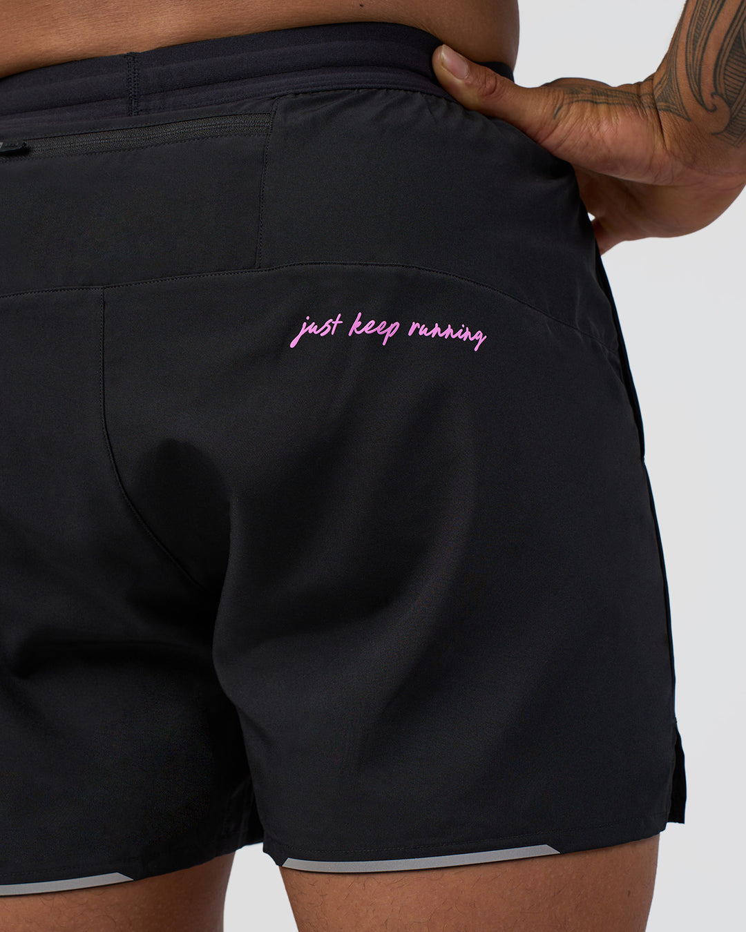 Man wearing Pace 5" Lined Running Short - Black-Ultra Fuchsia | Model:Daarian | Size:M