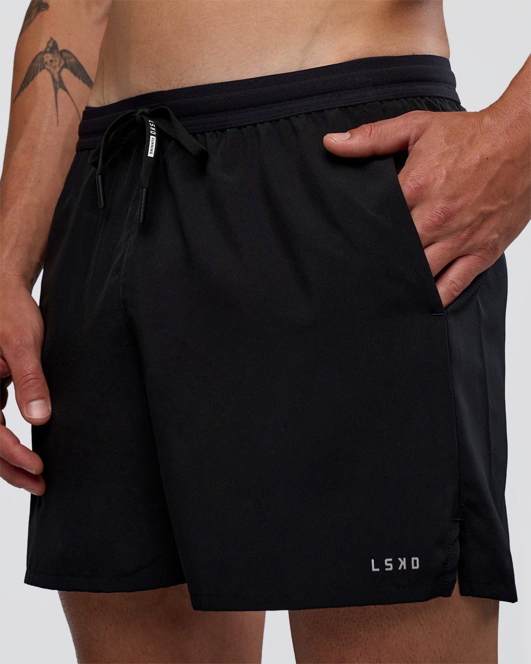 Man wearing Pace 5" Running Short - Black | Model:Konnor | Size:M