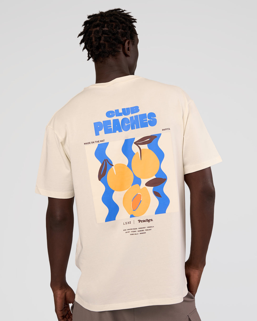 Man wearing Peaches x LSKD Collection FLXCotton Oversize Tee - Off White | Model:Okello | Size:M