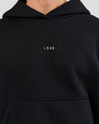 Man wearing Pride Sticker Boxy Hoodie - Black | Model:Albert | Size:M