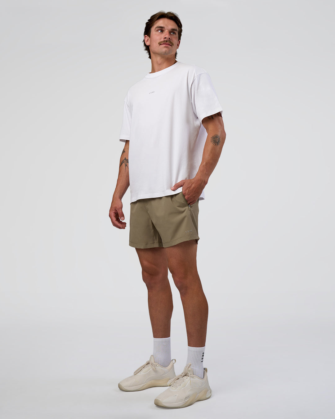 Man wearing Rep 5" Performance Short - Greige | Model:Konnor | Size:M
