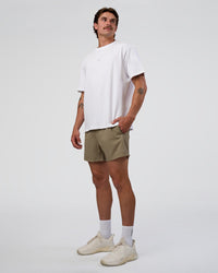 Man wearing Rep 5" Performance Short - Greige | Model:Konnor | Size:M
