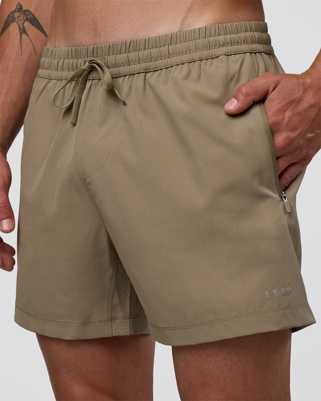 Man wearing Rep 5" Performance Short - Greige | Model:Konnor | Size:M