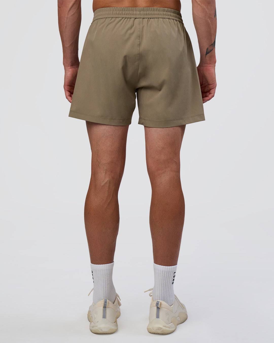 Man wearing Rep 5" Performance Short - Greige | Model:Konnor | Size:M