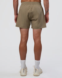 Man wearing Rep 5" Performance Short - Greige | Model:Konnor | Size:M
