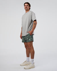 Man wearing Rep 5" Performance Short - Washed Camo Carbon | Model:Konnor | Size:M