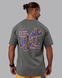 Man wearing Rise & Lift Washed FLXCotton Oversized Tee - Graphite-Purple Opulence | Model:Jaiden | Size:M