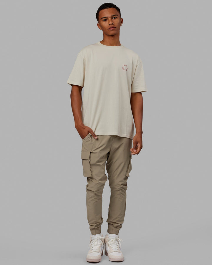 Man wearing Unisex Rotate Tee Oversize - Bone-Mineral Red