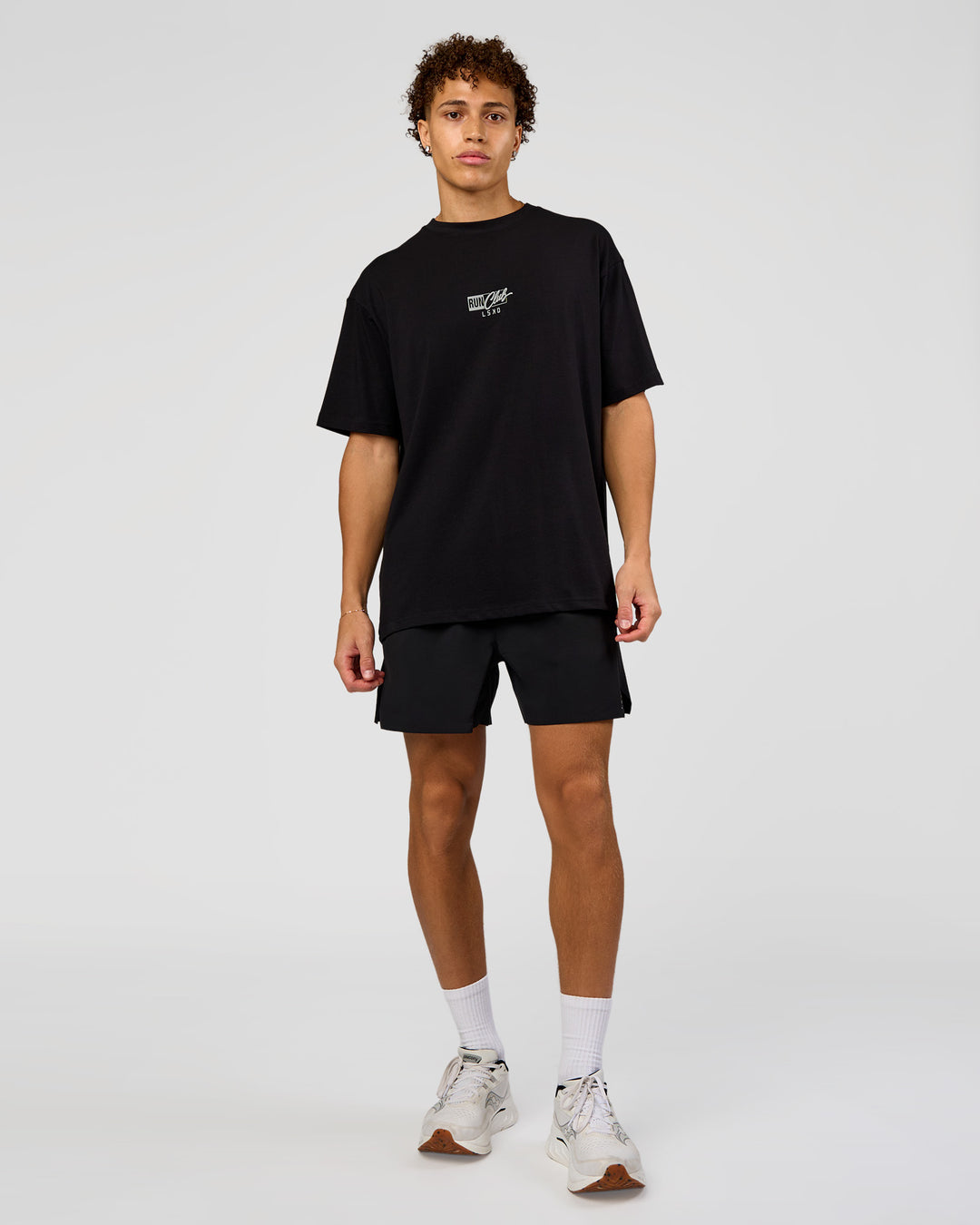 Man wearing Run Club Script FLXCotton Oversized Tee - Black-Alloy | Model:Leandro | Size:M